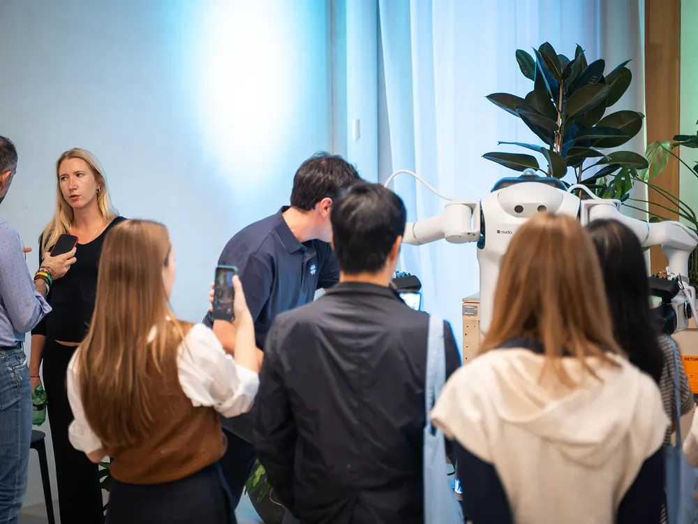 Visitors gathered around the sudo robot at a bothaus event