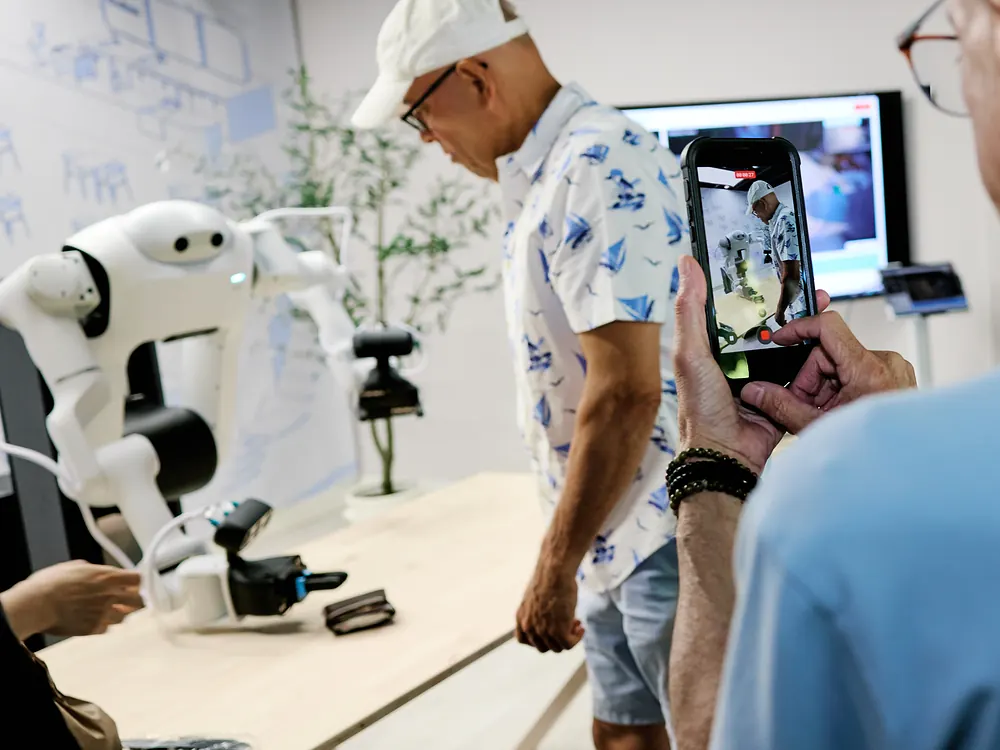 A visitor filming the sudo robot during a live demo