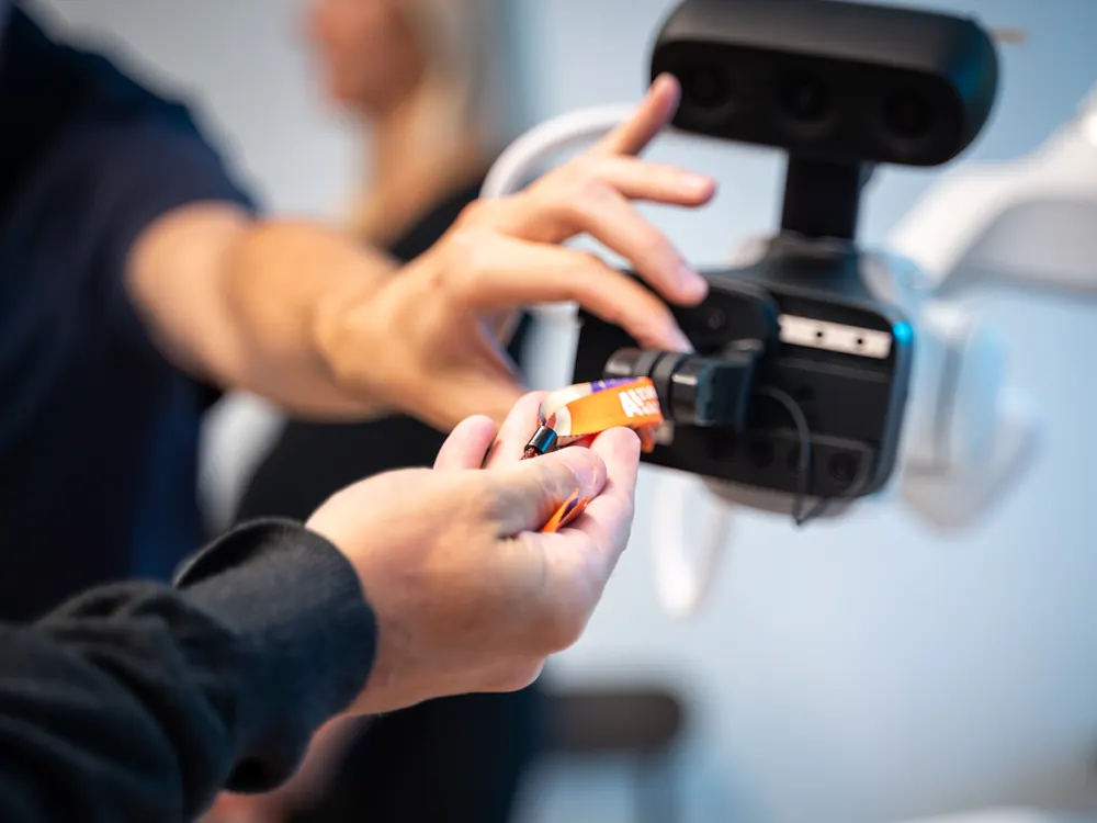 A visitor passing an object into the sudo robot's gripper